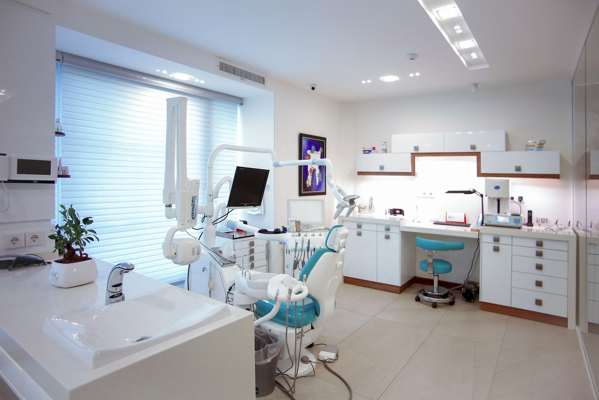 A a clinic waiting area with comfortable seating, artwork and warm neutral surfaces